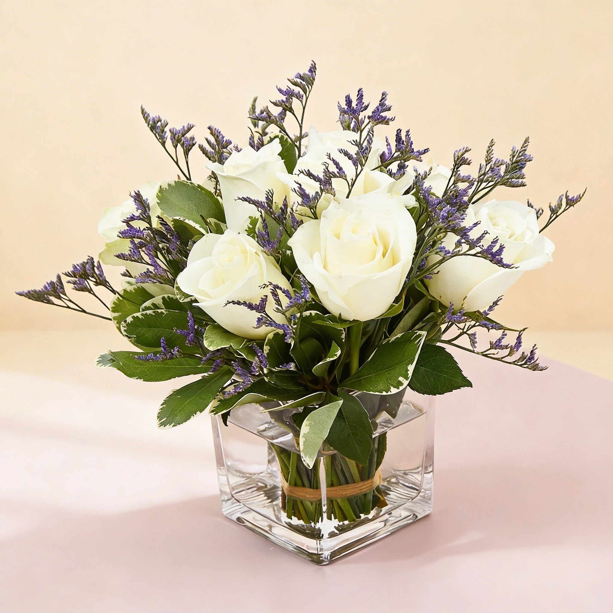 باقة أنيقة من الورود البيضاء في مزهرية